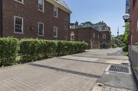 an empty street with brick walls and brick walkwaying down it to the top floor