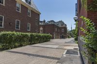 an empty street with brick walls and brick walkwaying down it to the top floor