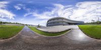 the circular fish eye view of a building and a curve in front of the road