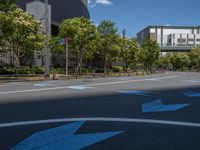 empty road with white lines on the streets of city area against cloudy blue sky on a sunny day