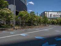 empty road with white lines on the streets of city area against cloudy blue sky on a sunny day