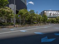 empty road with white lines on the streets of city area against cloudy blue sky on a sunny day