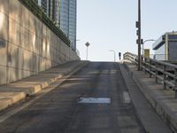 a city street with empty benches at the end of the road in a sunny day
