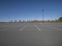 a empty parking lot with multiple spots for cars to park in the opposite direction of the way