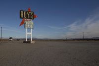 there is a sign that says royl's motel written on it in the middle of a desert