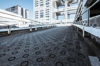 a walkway in front of some skyscrapers and buildings that look like they were in the process of falling