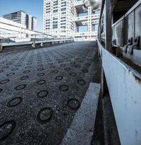 a walkway in front of some skyscrapers and buildings that look like they were in the process of falling