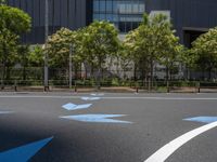 empty road with white lines on the streets of city area against cloudy blue sky on a sunny day