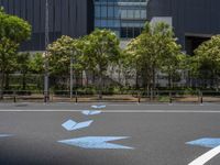 empty road with white lines on the streets of city area against cloudy blue sky on a sunny day