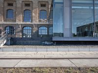 the train station is covered in graffiti outside the building, with people on the walkway