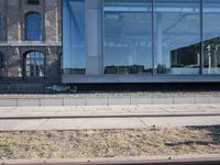 the train station is covered in graffiti outside the building, with people on the walkway