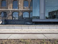 the train station is covered in graffiti outside the building, with people on the walkway