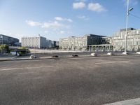 a highway going towards a building near some trees and bushes in front of it in the city