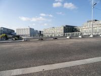 a highway going towards a building near some trees and bushes in front of it in the city