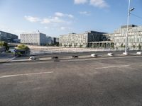 a highway going towards a building near some trees and bushes in front of it in the city