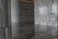a room with gray marble walls and wooden ceilings as well as a reflection of the door