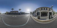 fish - eye lens image of a shopping street corner and a store front with an empty parking space