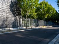 a sidewalk in the city that has a number of trees and some building on both side