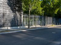 a sidewalk in the city that has a number of trees and some building on both side