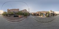 this image shows a fish eye view of the city from the sidewalk in an angle