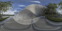 a skate boarder performs tricks on the rim of a ramp at a skate park