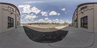 an empty skateboard park with clouds in the sky above the rinks with people on it