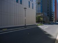 a motorcycle rider riding a bike through a city street in a red suit, red shoes, and sunglasses