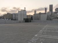 City skyline at dawn with buildings, roads, and infrastructure