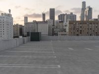 City skyline at dawn with buildings, roads, and infrastructure