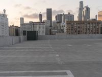 City skyline at dawn with buildings, roads, and infrastructure