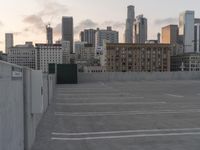 City skyline at dawn with buildings, roads, and infrastructure