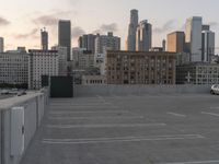 City skyline at dawn with buildings, roads, and infrastructure