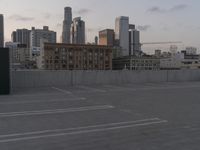 City skyline at dawn with buildings, roads, and infrastructure