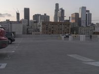 City skyline at dawn with buildings, roads, and infrastructure