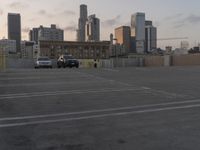 City skyline at dawn with buildings, roads, and infrastructure