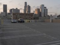 City skyline at dawn with buildings, roads, and infrastructure
