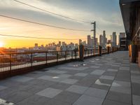 City Skyline at Dawn: Sun Visible on the Horizon