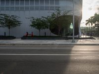 the corner in a street with a fire hydrant near it on it's curb