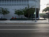 the corner in a street with a fire hydrant near it on it's curb