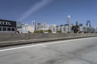 a view of city skyline from the highway showing skyscrapers in background of photograph and a man in distance
