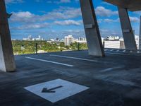 the view from a concrete walkway in a city area with sky and trees around it