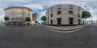 an image of a city street from a fish - eye lens lense of two buildings with palm trees in the background