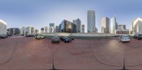 a 360 - view image of cars parked near the city skyline in a parking lot