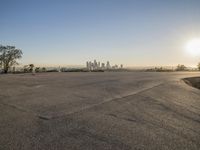 the sky is clear and empty of cars or vehicles and skyscrapers as the sun sets over a large urban skyline