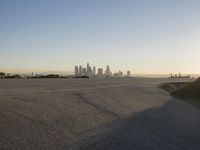 the sky is clear and empty of cars or vehicles and skyscrapers as the sun sets over a large urban skyline