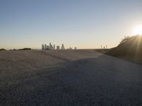 the sky is clear and empty of cars or vehicles and skyscrapers as the sun sets over a large urban skyline