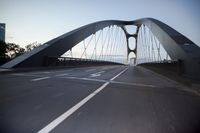 a car going over a bridge at sunset with city skyline in the background as seen from a moving vehicle