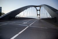 a car going over a bridge at sunset with city skyline in the background as seen from a moving vehicle