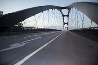 a car going over a bridge at sunset with city skyline in the background as seen from a moving vehicle