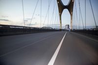 a car going over a bridge at sunset with city skyline in the background as seen from a moving vehicle